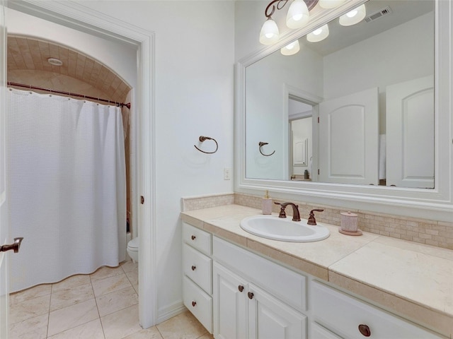 bathroom with vanity, tile patterned floors, toilet, and a shower with shower curtain