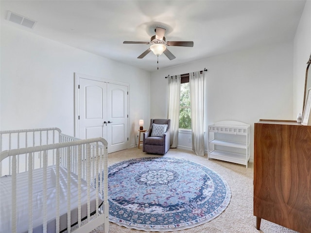 carpeted bedroom featuring a closet and ceiling fan