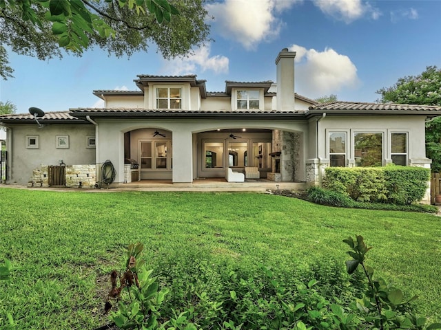 rear view of house with a yard, a patio, and ceiling fan