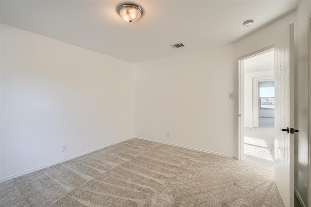 unfurnished room with light carpet