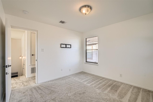 empty room featuring light colored carpet