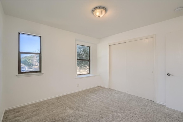 unfurnished bedroom with carpet and a closet