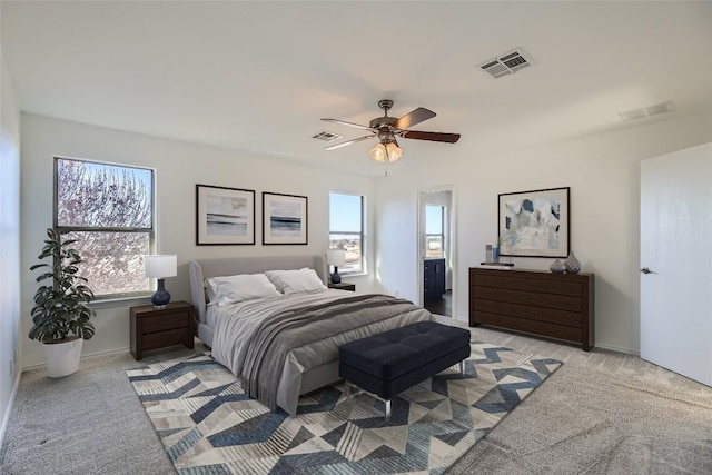 bedroom featuring light colored carpet and ceiling fan