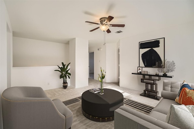 carpeted living room featuring ceiling fan