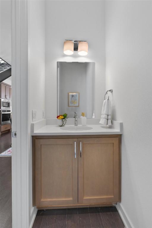 bathroom with vanity and hardwood / wood-style floors