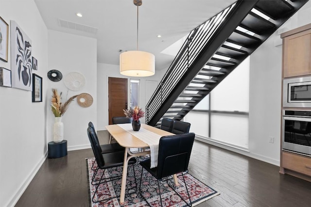 dining room with dark hardwood / wood-style flooring