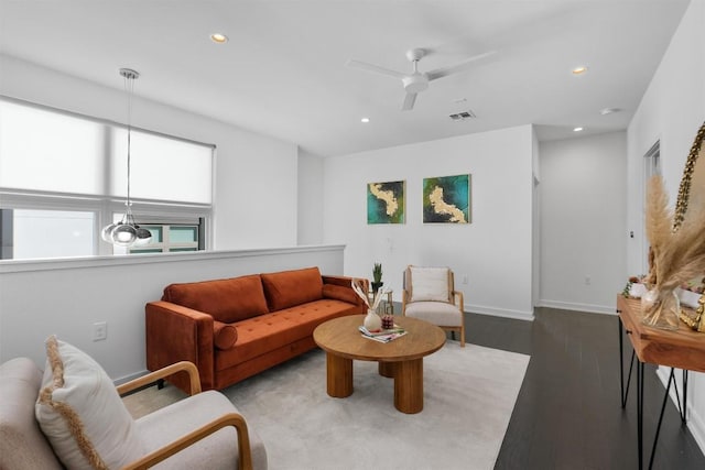 living room featuring hardwood / wood-style floors and ceiling fan