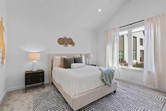 carpeted bedroom with lofted ceiling