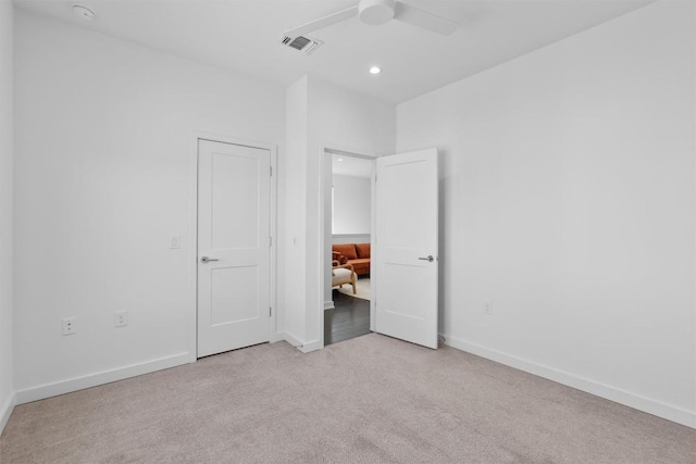 unfurnished bedroom with light carpet and ceiling fan