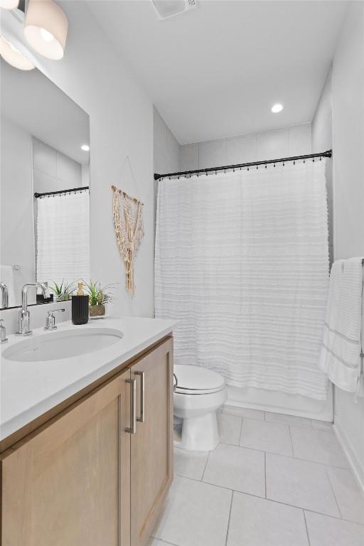 bathroom with vanity, toilet, and tile patterned flooring