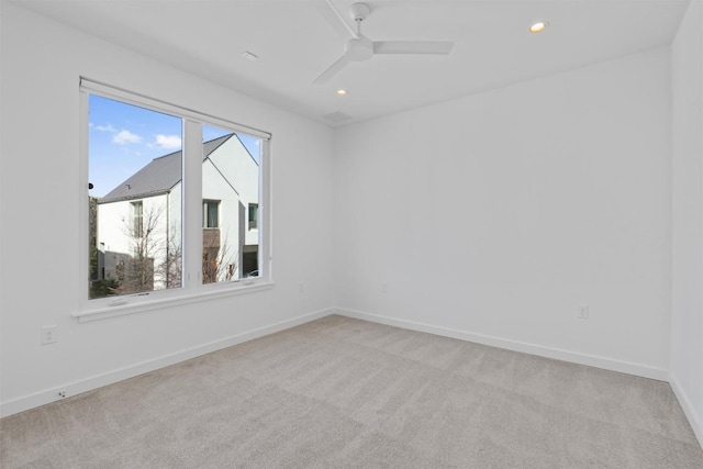 unfurnished room featuring light colored carpet and ceiling fan