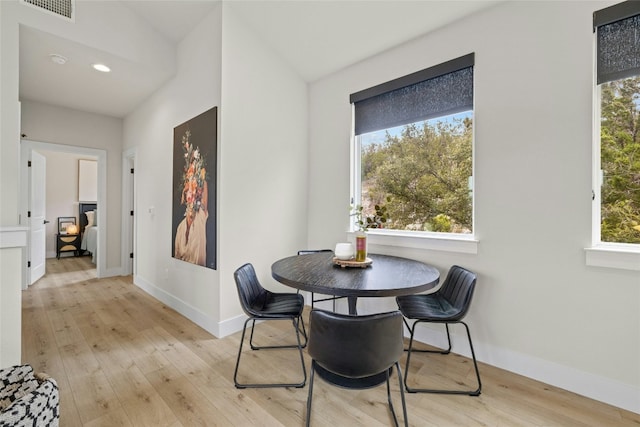 dining space with a healthy amount of sunlight and light hardwood / wood-style floors