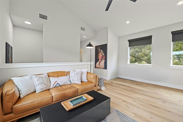 living room with baseboards, visible vents, lofted ceiling, wood finished floors, and recessed lighting