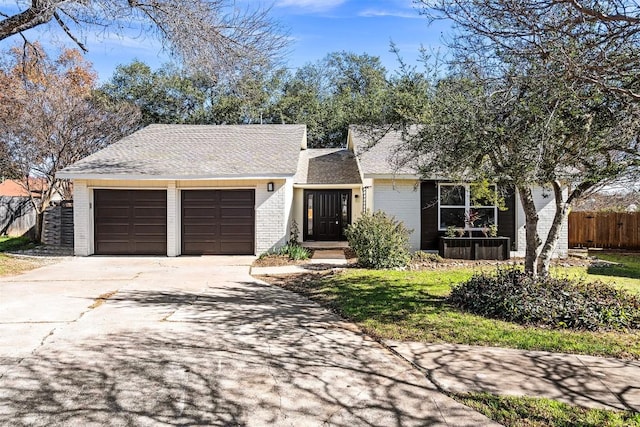 single story home featuring a garage and a front lawn