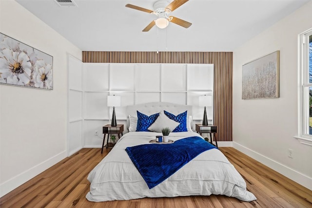 bedroom with ceiling fan and light hardwood / wood-style flooring