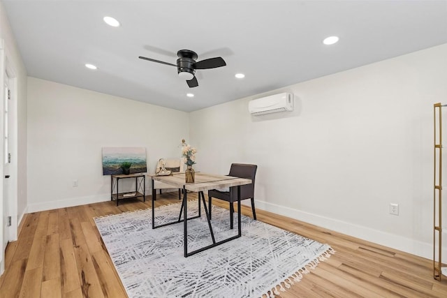 home office featuring ceiling fan, wood-type flooring, and a wall unit AC