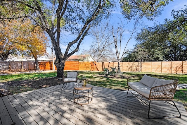 wooden terrace featuring a lawn