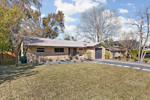 ranch-style house featuring a garage and a front yard