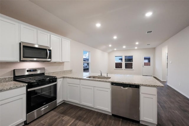 kitchen featuring white cabinetry, sink, stainless steel appliances, and kitchen peninsula