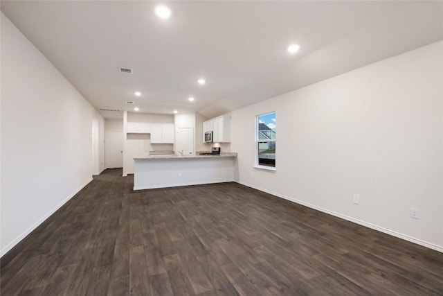 unfurnished living room featuring dark hardwood / wood-style floors and sink