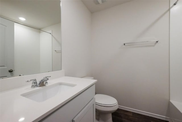 bathroom featuring vanity, toilet, hardwood / wood-style floors, and a shower