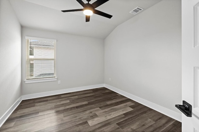 spare room with lofted ceiling, dark wood-type flooring, and ceiling fan