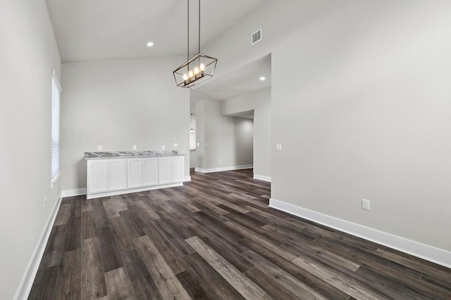 unfurnished dining area featuring dark hardwood / wood-style floors and a notable chandelier