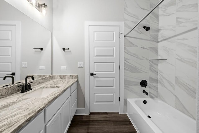 bathroom featuring vanity, tiled shower / bath combo, and hardwood / wood-style floors