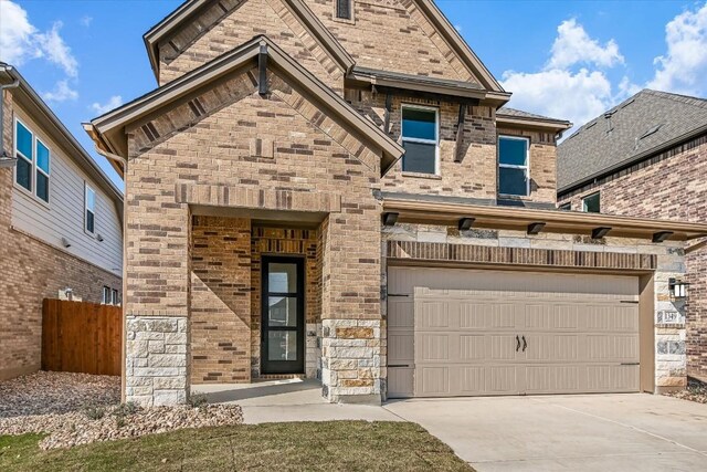 1349 S Brook Dr, Leander, TX 78641 - view of front of property featuring brick siding, driveway, and a garage