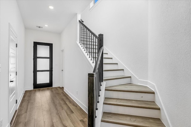 foyer entrance with light hardwood / wood-style floors