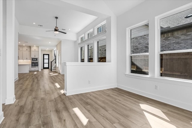 unfurnished living room with light hardwood / wood-style floors and ceiling fan