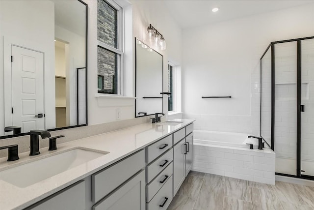 bathroom featuring independent shower and bath and vanity