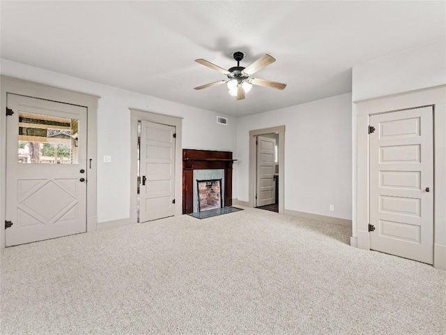 unfurnished living room featuring carpet floors and ceiling fan