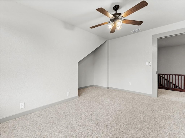 bonus room featuring ceiling fan, light colored carpet, and lofted ceiling