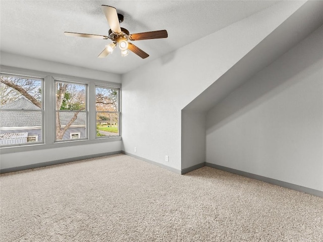 additional living space featuring ceiling fan and a textured ceiling