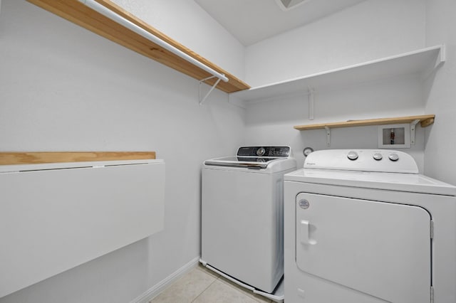 laundry area featuring light tile patterned flooring and washing machine and clothes dryer