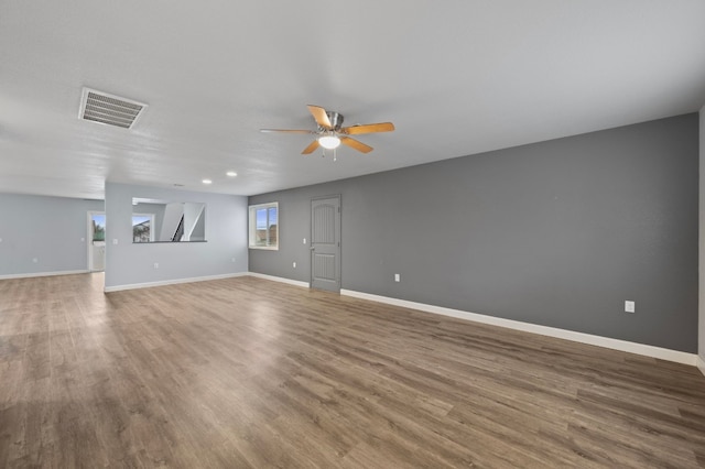 unfurnished living room featuring ceiling fan and hardwood / wood-style floors