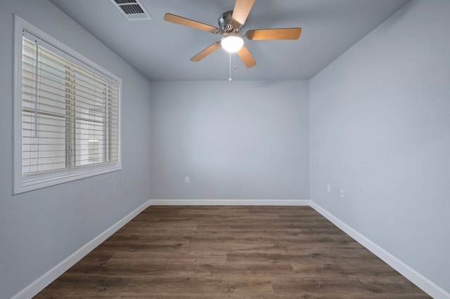 spare room with dark hardwood / wood-style flooring and ceiling fan