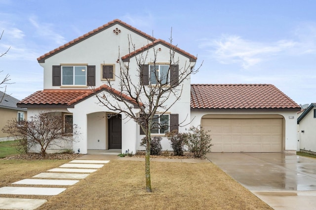 mediterranean / spanish-style house with a garage and a front yard