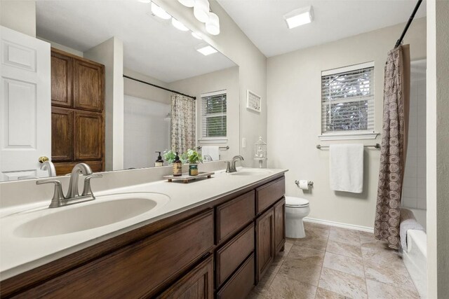 full bathroom featuring shower / bathtub combination with curtain, a healthy amount of sunlight, toilet, and vanity