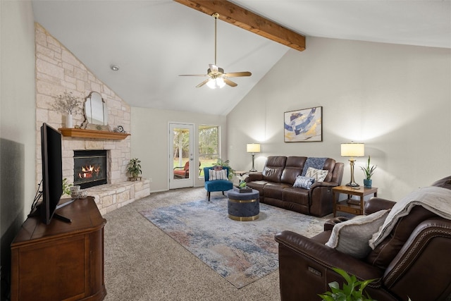 carpeted living room with ceiling fan, a fireplace, high vaulted ceiling, and beamed ceiling