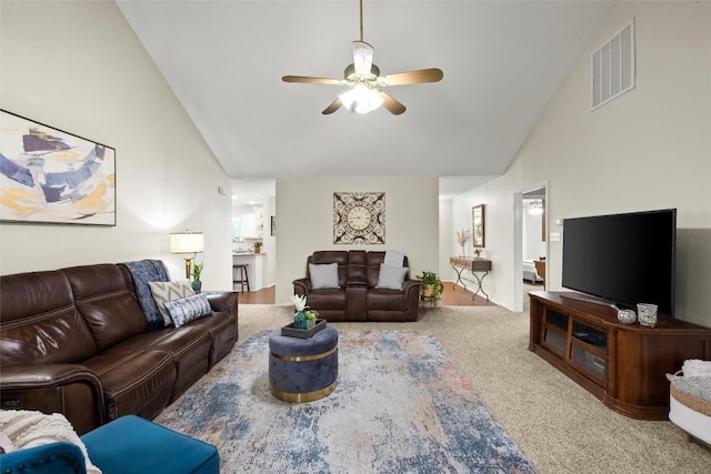 living room featuring ceiling fan, carpet flooring, and high vaulted ceiling