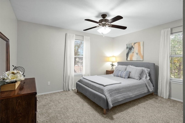 bedroom with light colored carpet and ceiling fan