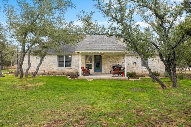 rear view of property featuring a patio and a lawn