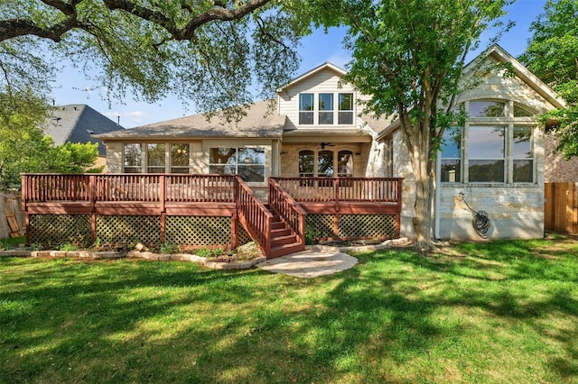 back of property with a lawn and a wooden deck