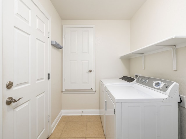 laundry area featuring light tile patterned floors and washer and dryer