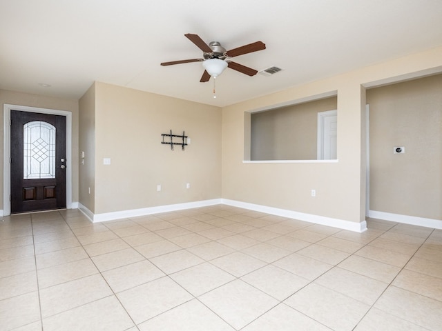 tiled entryway featuring ceiling fan