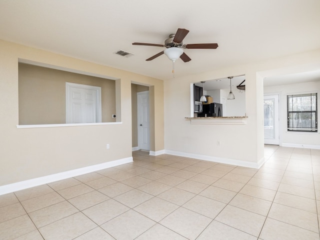 unfurnished living room featuring light tile patterned floors and ceiling fan