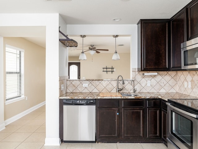 kitchen with sink, tasteful backsplash, dark brown cabinets, pendant lighting, and stainless steel appliances