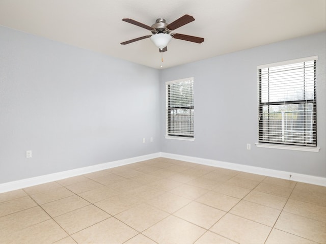 unfurnished room with ceiling fan and light tile patterned floors